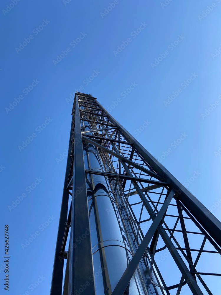 shiny pipe of thermal station against the blue sky