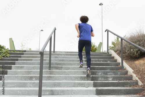 a man practicing sport by climbing stairs in the street
