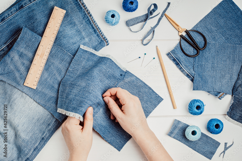 Old jeans upcycling idea. Crafting with denim, recycling old clothers,  hobby, diy activity. Sustainable, zero waste lifestyle concept Photos |  Adobe Stock