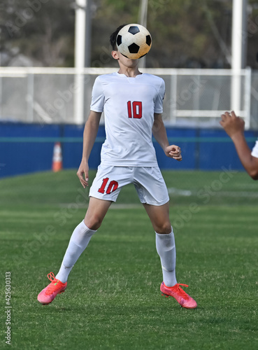Young athletic boy making amazing plays during a soccer match © Joe