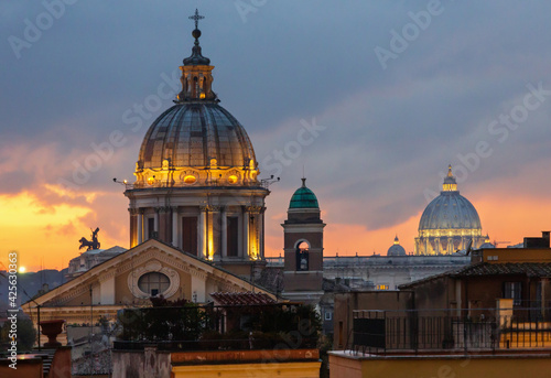 Photography Rome City night illuminated  view  from top of Spanish Steps with Sant Ambrogio e Carlo al Corso (or San Carlo al Corso) basilica top and Saint Peter Basilica dome (behind), Italy