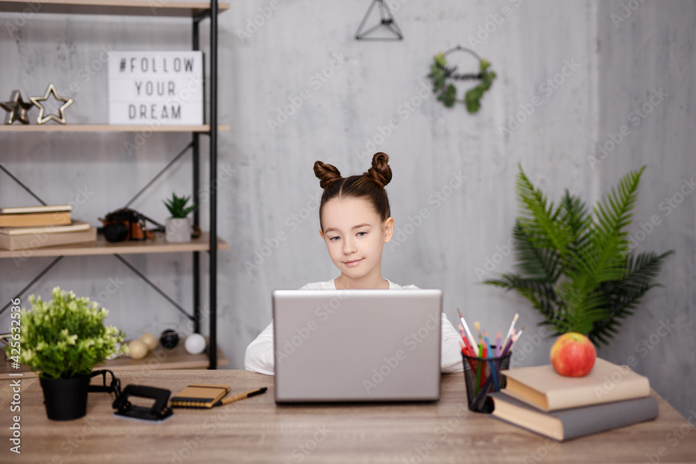 school, homework, internet and distance education concept - cute school girl using laptop and studying online at home school, homework, internet and distance education concept - cute school girl using laptop and studying online at home