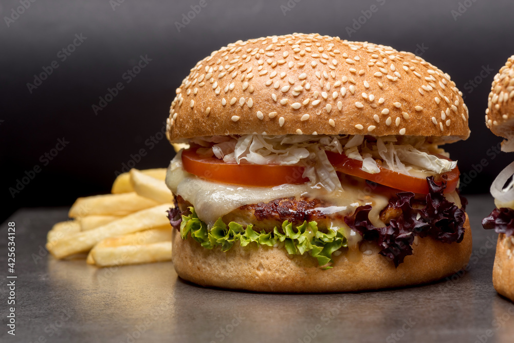 Set burgers with potatoes on the dark background Set burgers with potatoes on the dark background