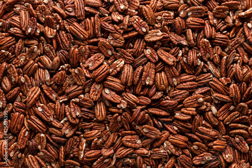 Fototapeta Naklejka Na Ścianę i Meble -  Pecan nuts background, top view. Pecans fruits texture, close-up