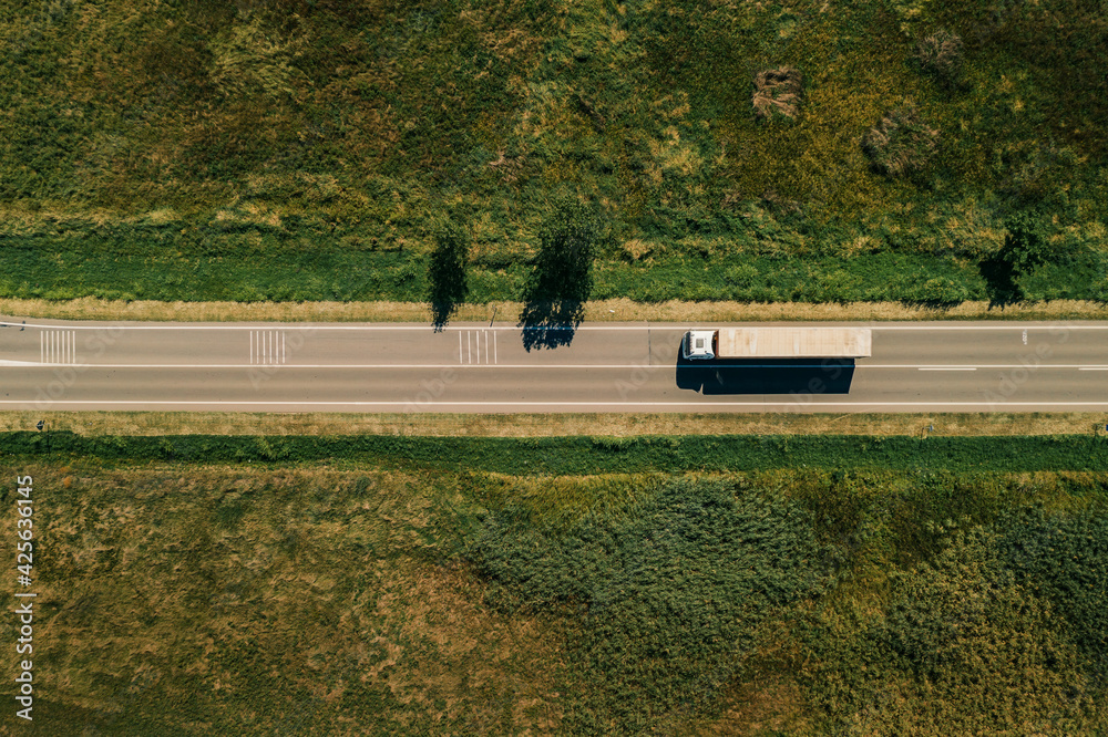 Large freight transporter semi-truck on the road, aerial view