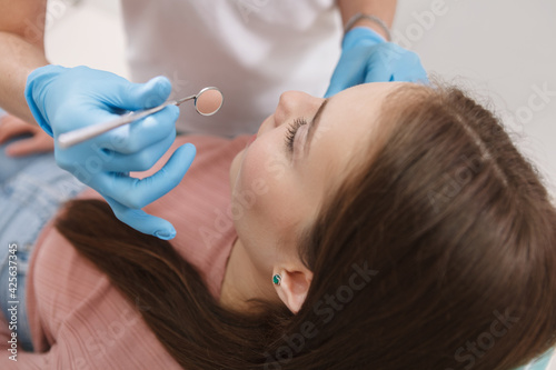 Close up of a female patient getting her teeth checked by dentist
