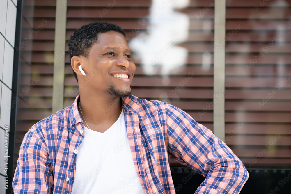 African american man sitting at a store window. African american man sitting at a store window.