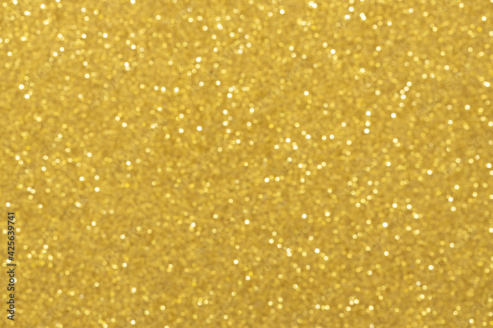 Abstract gold blurred background with numerous colourful bright festive bokeh. Texture with copy space for text. Celebration, holidays concept. Horizontal. Soft selective focus Abstract gold blurred background with numerous colourful bright festive bokeh. Texture with copy space for text. Celebration, holidays concept. Horizontal. Soft selective focus