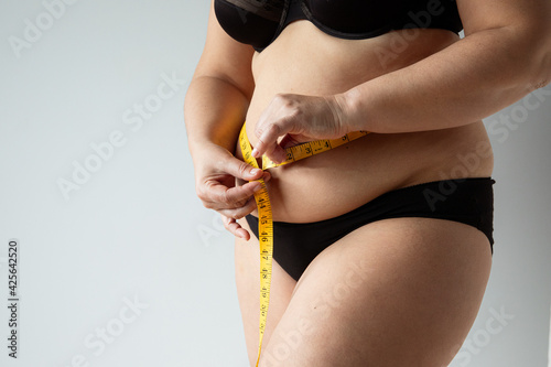 middle aged curvy woman body with belly diet concept