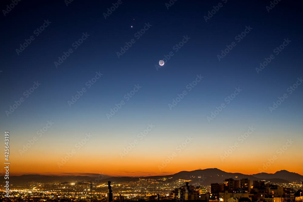Fototapeta premium Moon dusk over the city