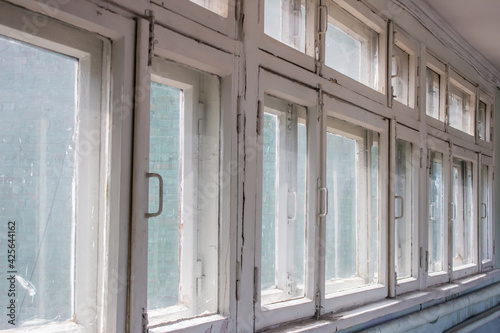 Old vintage wooden framed windows with dirty glass  full wall windows