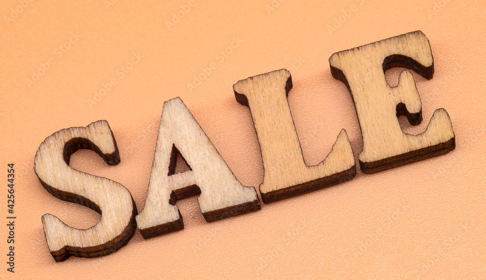 Large letters sale, action. Discount sale. Wooden letters discount on orange background. Large letters sale, action. Discount sale. Wooden letters discount on orange background.