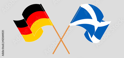 Crossed and waving flags of Germany and Scotland