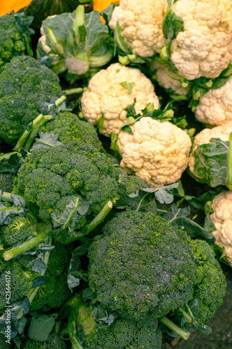 broccoli and cauliflowers for sale in an open-air urban vegetable market photo