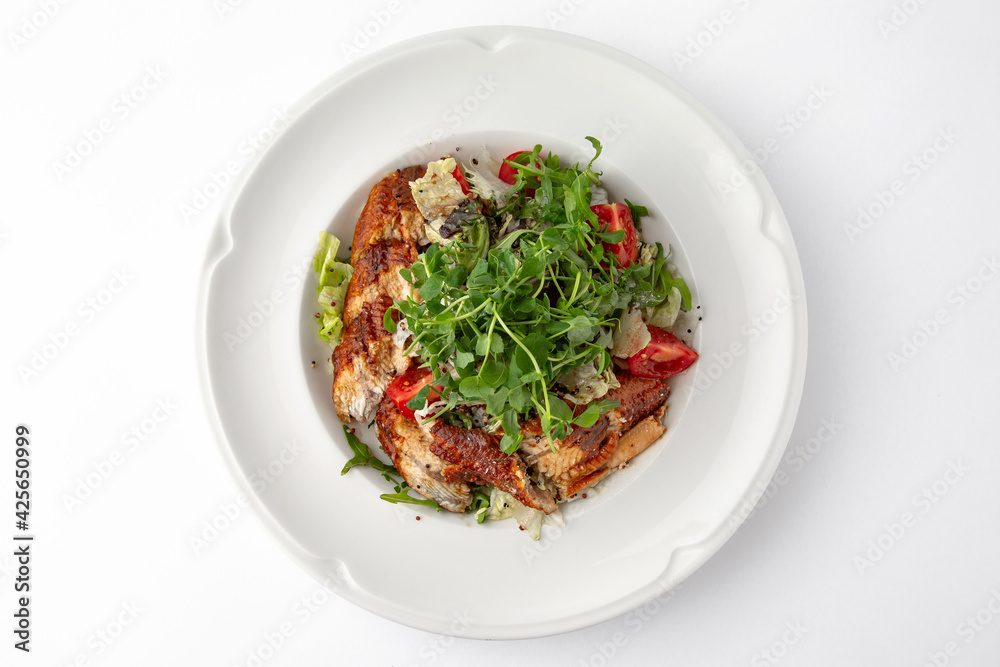 Salad of smoked eel, unagi sauce and greens with vegetables. Banquet festive dishes. Gourmet restaurant menu. White background. Salad of smoked eel, unagi sauce and greens with vegetables. Banquet festive dishes. Gourmet restaurant menu. White background.
