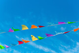 Colorful bunting flags in the wind. Festive background for holidays, anniversary, celebration. Multi-colored flag 