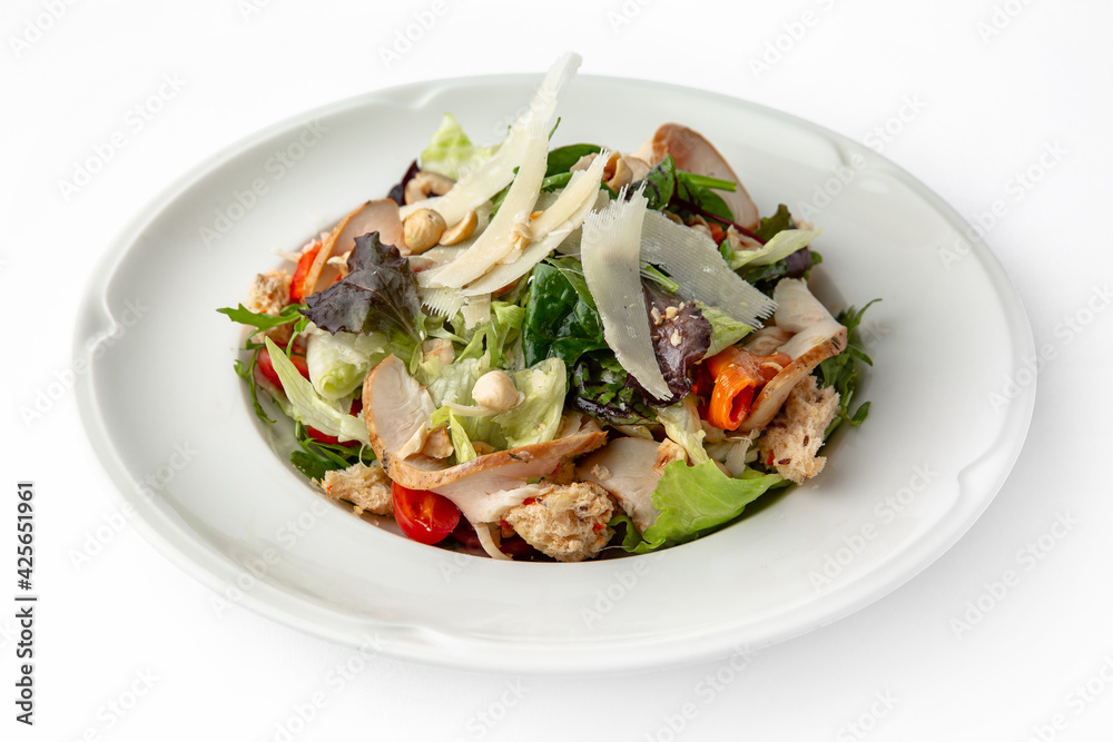 Salad with meat, nuts, seeds, vegetables and herbs. Banquet festive dishes. Gourmet restaurant menu. White background. Salad with meat, nuts, seeds, vegetables and herbs. Banquet festive dishes. Gourmet restaurant menu. White background.