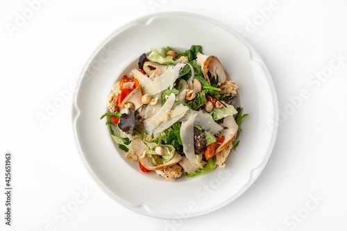 Salad with meat, nuts, seeds, vegetables and herbs. Banquet festive dishes. Gourmet restaurant menu. White background.