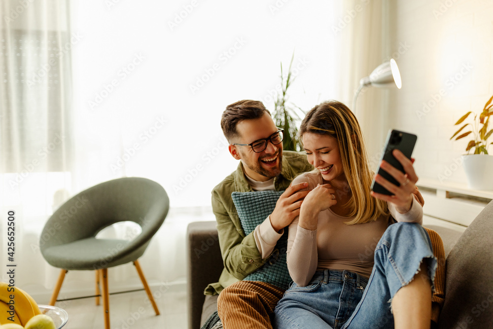 Ταπετσαρία Excited couple relax on couch feel euphoric win lottery online on cellphone