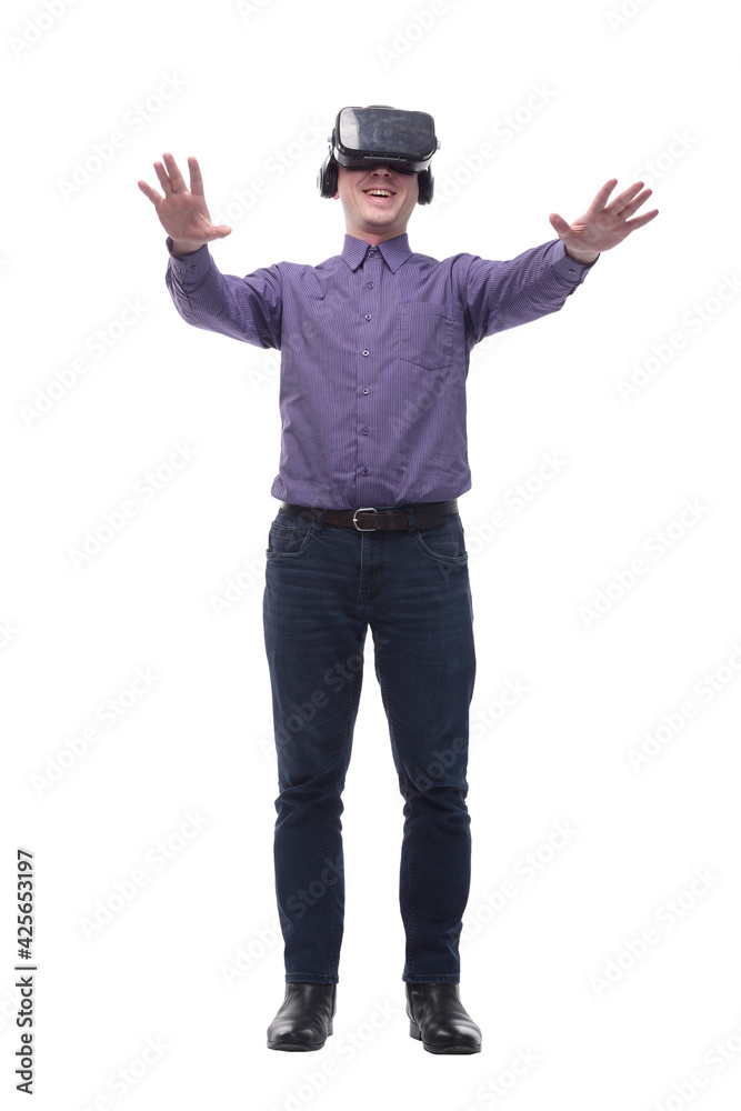 Excited man experiencing virtual reality via VR headset and touching something with his hands Excited man experiencing virtual reality via VR headset and touching something with his hands