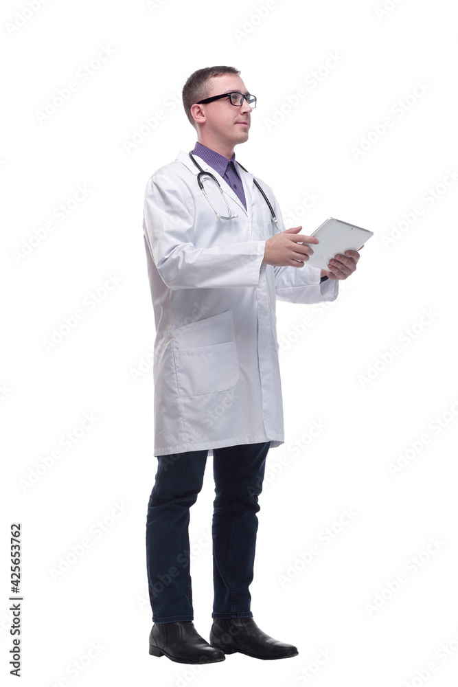Side view of confident doctor wearing uniform and glasses using digital tablet Side view of confident doctor wearing uniform and glasses using digital tablet