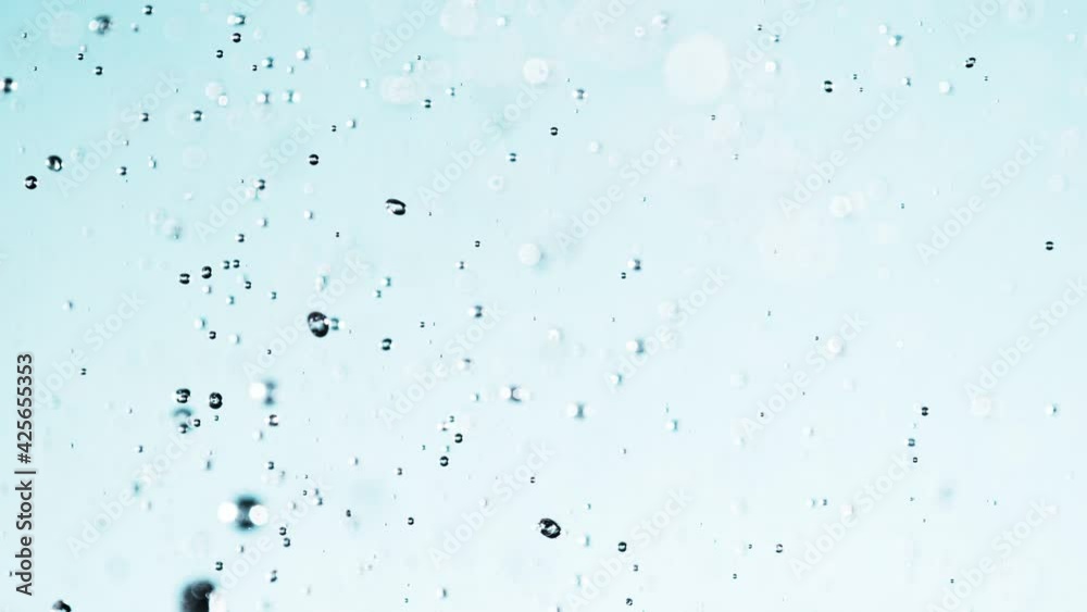 Super Slow Motion Shot of Water Splash on Light Blue Background at 1000fps. Super Slow Motion Shot of Water Splash on Light Blue Background at 1000fps.