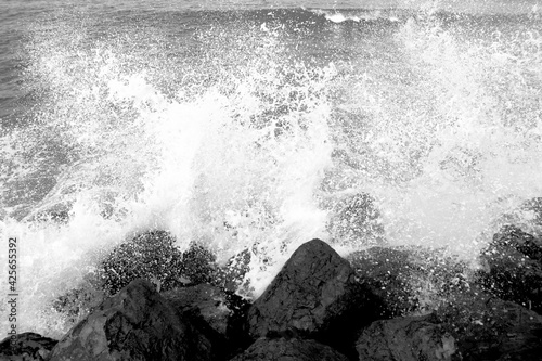 Waves crash on big stones 