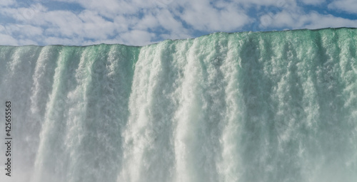 Close view of a water streams falling from the top of Horeseshoe Falls