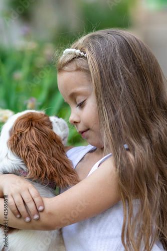 Girl hugging her favorite dog outdoors