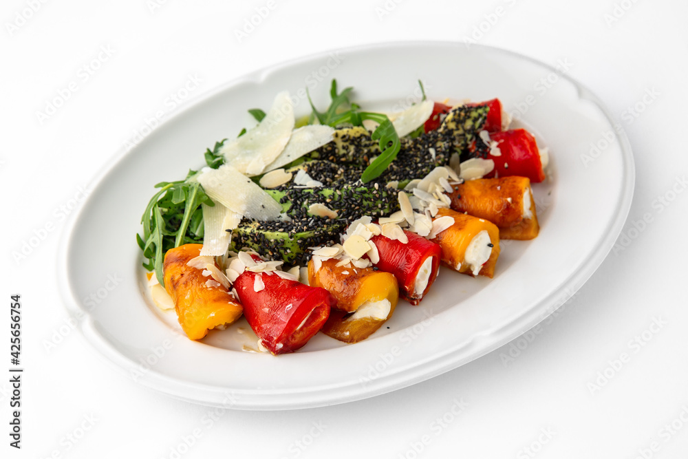 Appetizer of grilled sweet peppers. Rolls stuffed with cheese. Banquet festive dishes. Gourmet restaurant menu. White background. Appetizer of grilled sweet peppers. Rolls stuffed with cheese. Banquet festive dishes. Gourmet restaurant menu. White background.