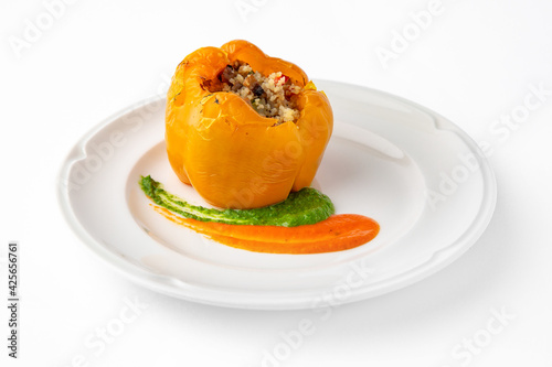Sweet peppers stuffed with rice, vegetables and meat, baked in the oven. Banquet festive dishes. Gourmet restaurant menu. White background. 