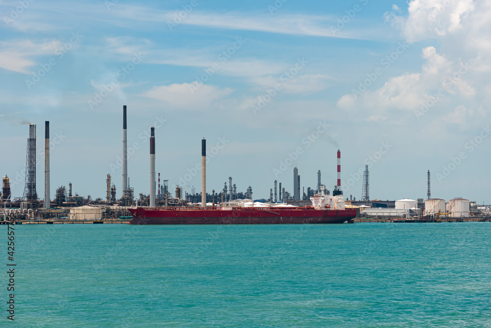 Singapore refinery - oil tanker ship berthed in oil terminal. Singapore refinery - oil tanker ship berthed in oil terminal.