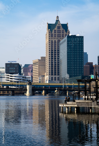 a landscape view of the Milwaukee, Wisconsin skyline at the Milwaukee River