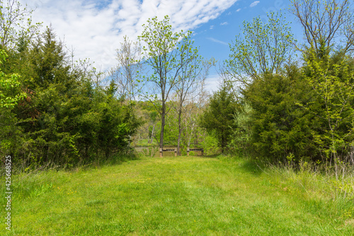 Two wooden benches sit alongside the Shenandoah River for hikers to rest. Copy space.