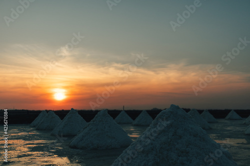 Colorful sunset landscape view of salt farm or salt pan in Thailand.