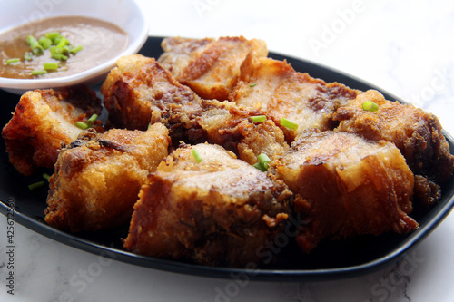 Freshly cooked Filipino food called Lechon Kawali or pan fried chopped crispy pork belly photo