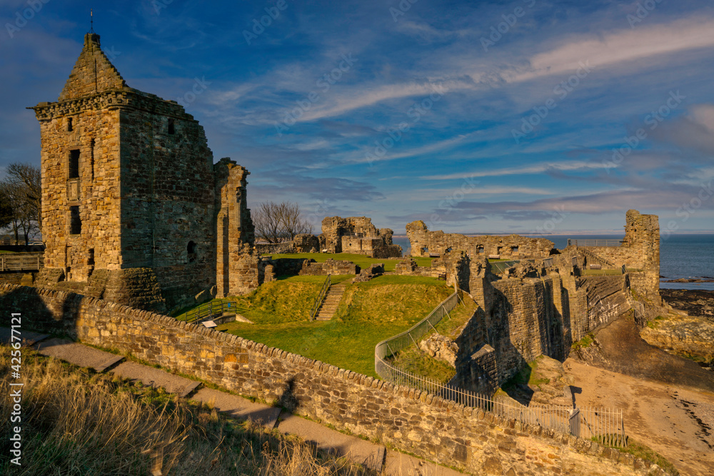 St Andrews castle Ruins with blue sky and streaky clouds at sunset, located in fife, Scotland.