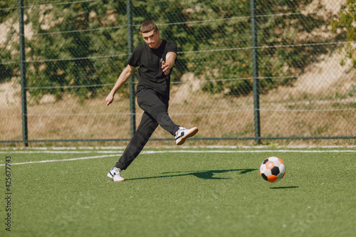 Sporman is playing football and practising with the ball