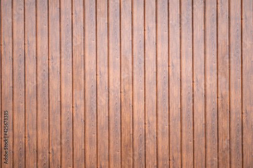 Wall made of brown wooden vertical planks texture.