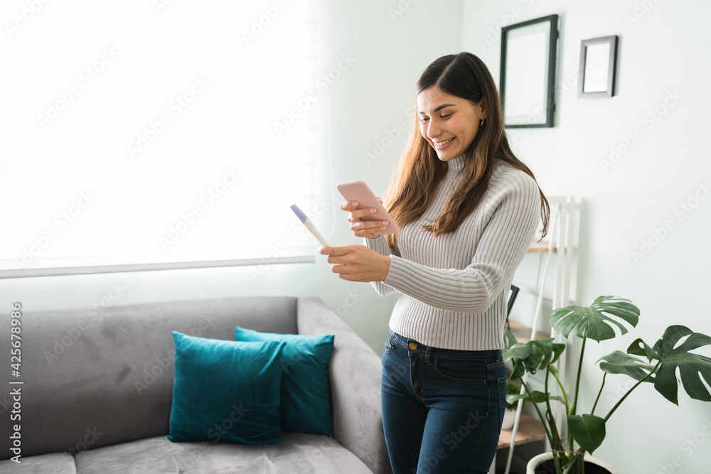 Girlfriend texting a picture of a pregnancy test to her partner Girlfriend texting a picture of a pregnancy test to her partner