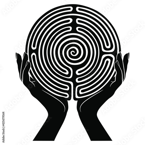 Two female hands holding round spiral maze or labyrinth symbol. Ariadne. Creative concept. Black and white silhouette. photo