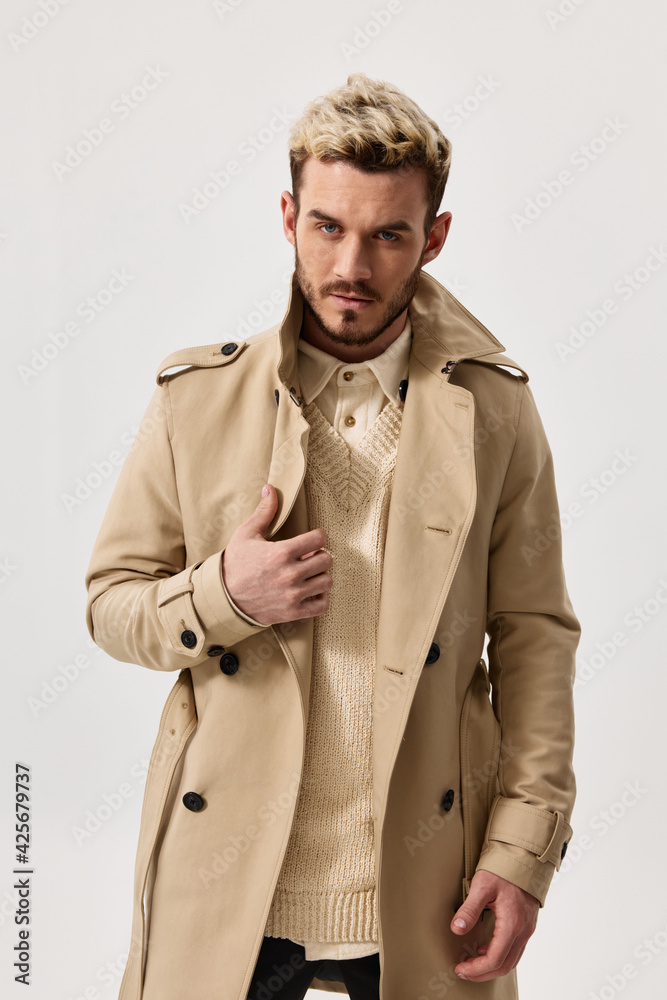 fashionable men in a light coat and sweater on an isolated background hairstyle model fashionable men in a light coat and sweater on an isolated background hairstyle model