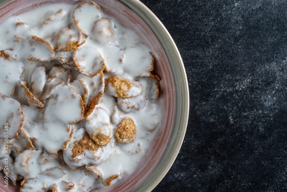 Whole grain glazed flakes with yogurt in plate. Healthy breakfast, whole grain muesli in a bowl