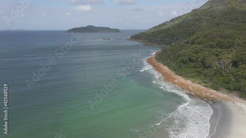 Rocky Coast Of Yacaaba Head Peninsula With John Gould Island In The Distance - Mount Yacaaba In Hawks Nest, NSW, Australia. - aerial photo