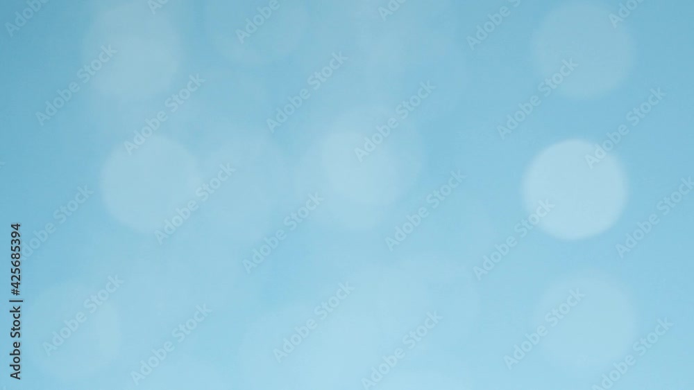 Blurred moving abstract white color light particles, blue background, lens flare Blurred moving abstract white color light particles, blue background, lens flare