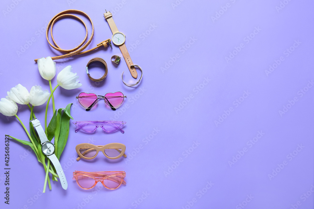 Obraz premium Stylish female accessories with flowers on color background