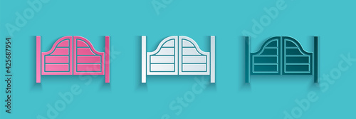 Paper cut Old western swinging saloon door icon isolated on blue background. Paper art style. Vector