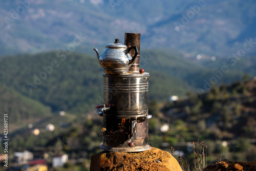 old teapot in mountains photo