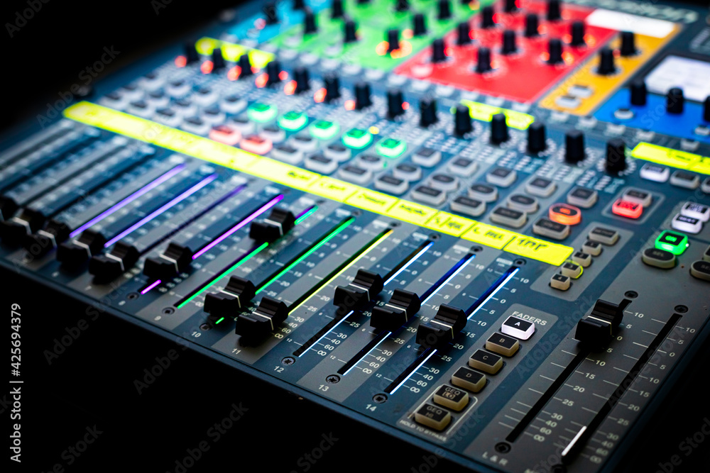 Sliders and buttons on Audio Mixing Desk at live event. Sliders and buttons on Audio Mixing Desk at live event.