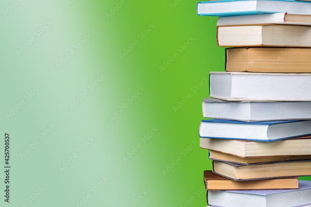 Collection of old books stack on green background Collection of old books stack on green background